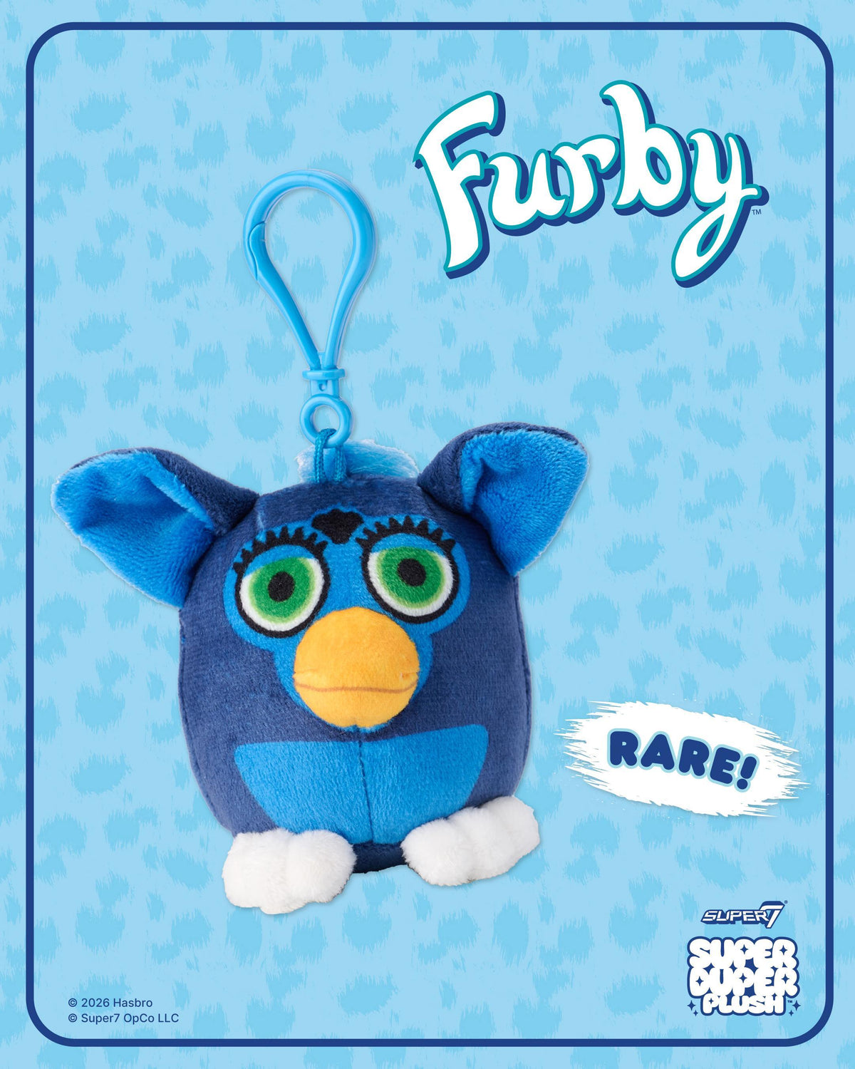 Blue Furby plush with green eyes and orange beak on a blue themed box with a rare label.