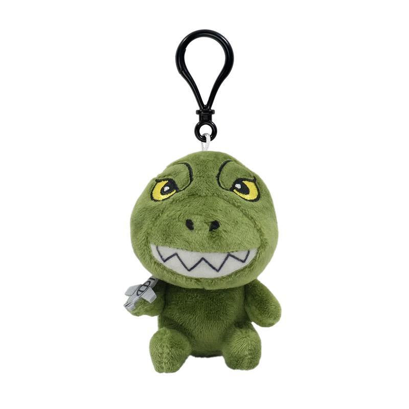 Front-facing green dinosaur plush keychain with yellow eyes and a silver accessory on its side.