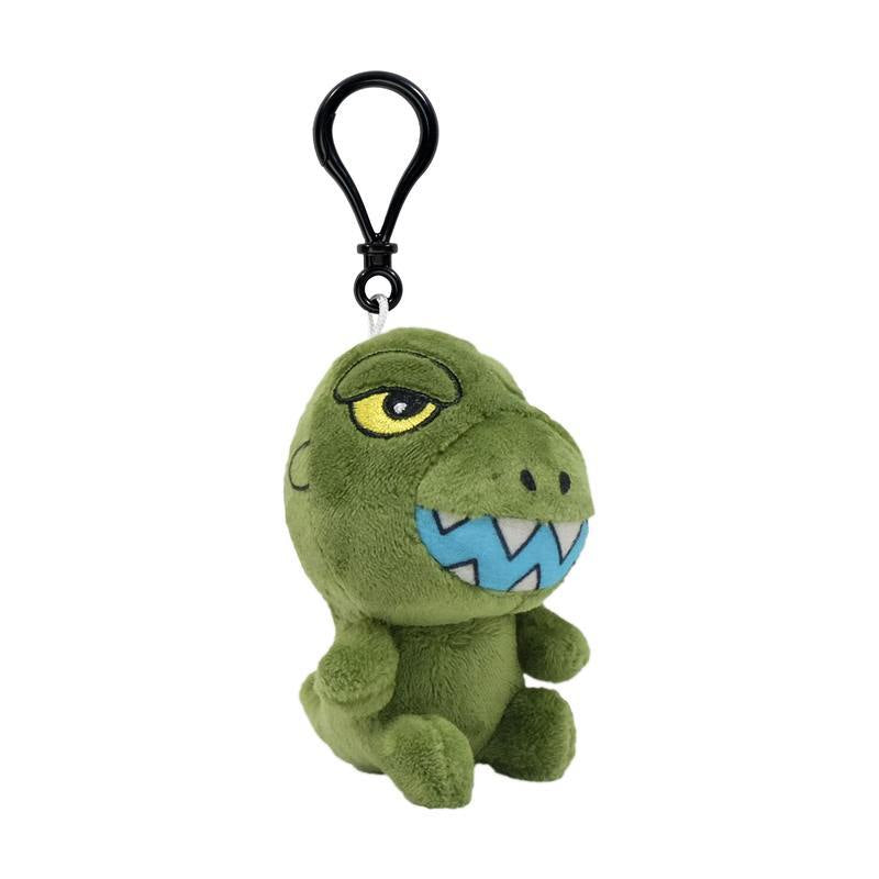 Side view of a green dinosaur plush keychain with a yellow eye and blue teeth, attached to a black clip.