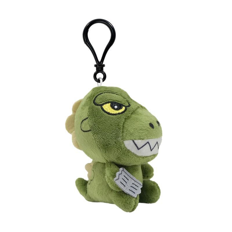 Side view of green dinosaur plush keychain with yellow eye and beige back plates attached to a black clip