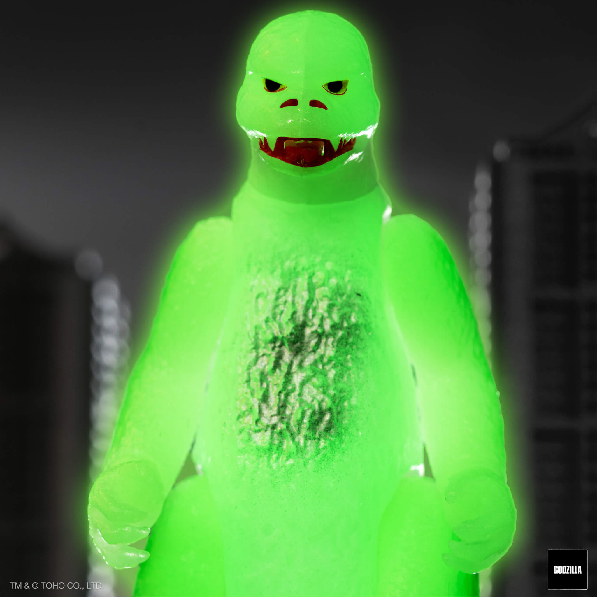 Neon green glowing Shogun Godzilla head against a dark background.
