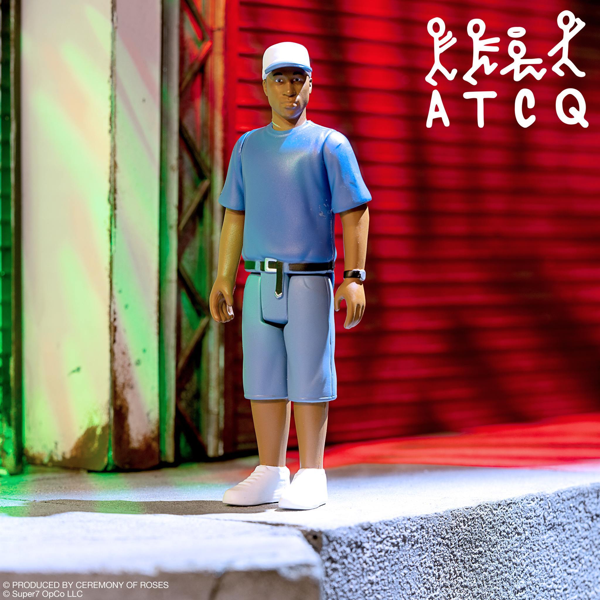 Tribe Called Quest Wave 2 Ali ReAction Figure in blue t-shirt, shorts, and white cap, urban backdrop