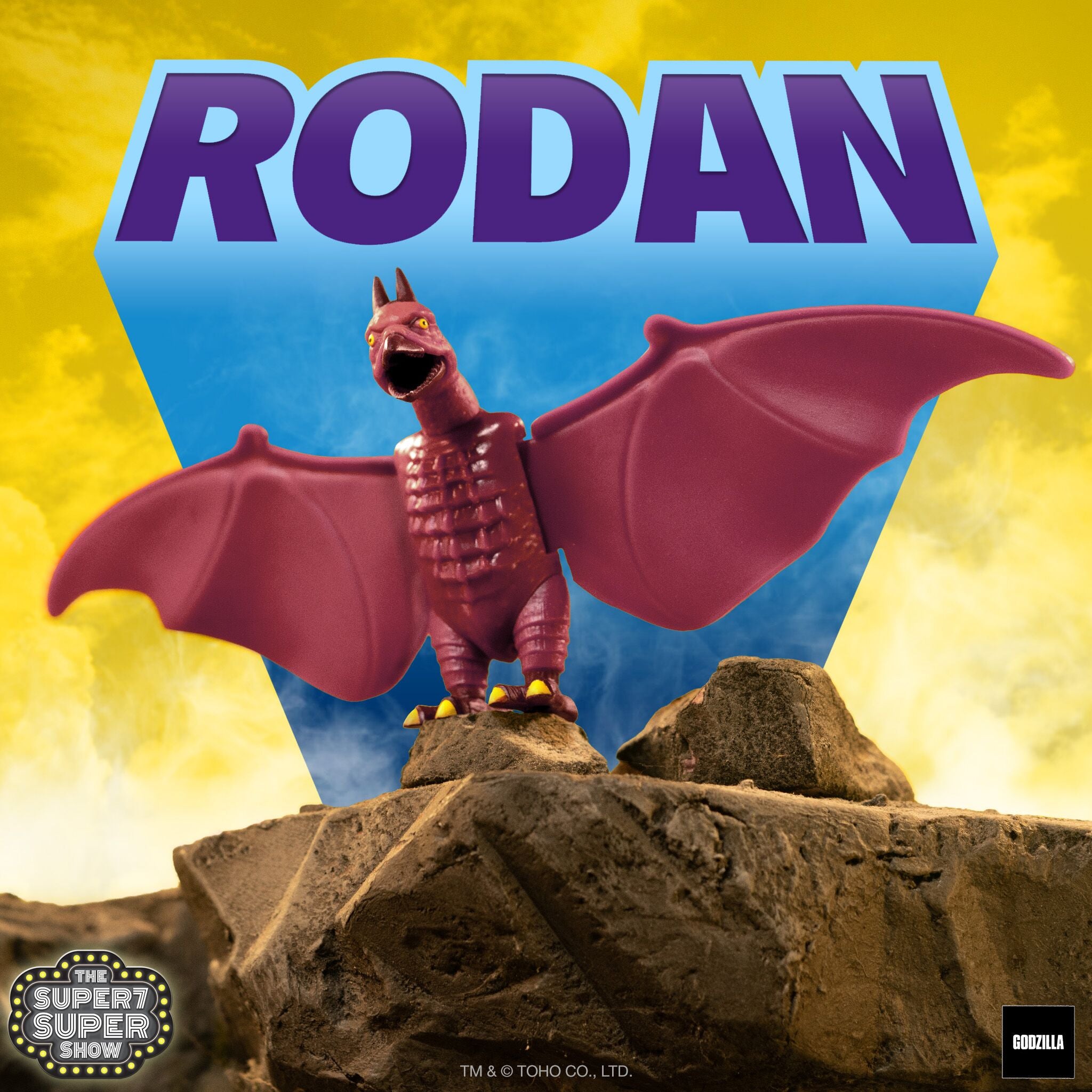 Rodan Shogun figure perched on rocks against a yellow sky on SDCC packaging artwork