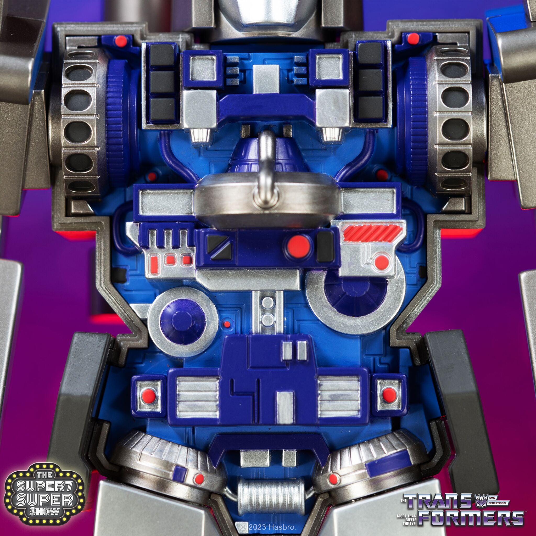 Close up of a blue and silver Transformer torso with a Decepticon emblem on the chest.