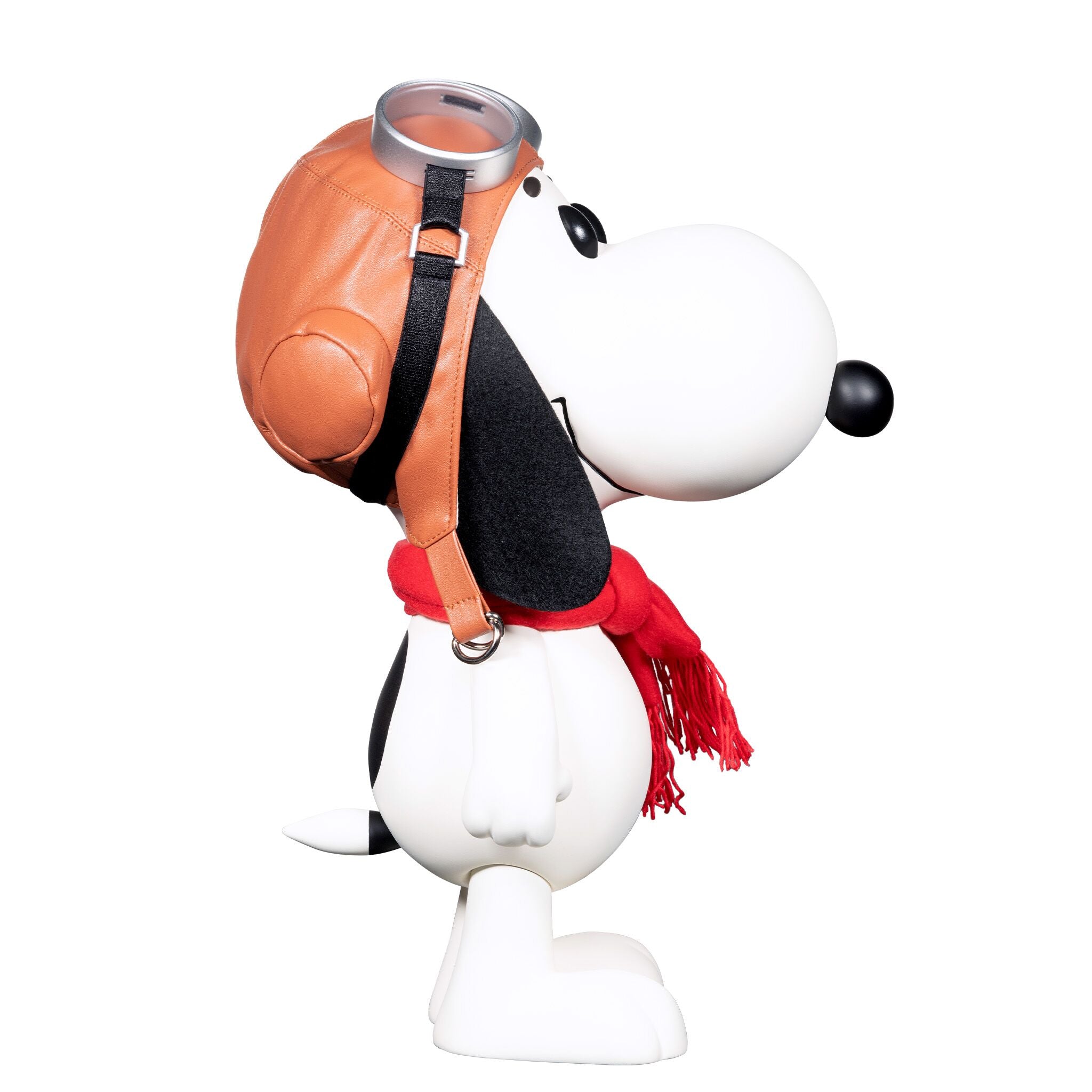 Close up of Snoopy Flying Ace vinyl figure in an orange pilot jacket with a black strap and silver buckle.