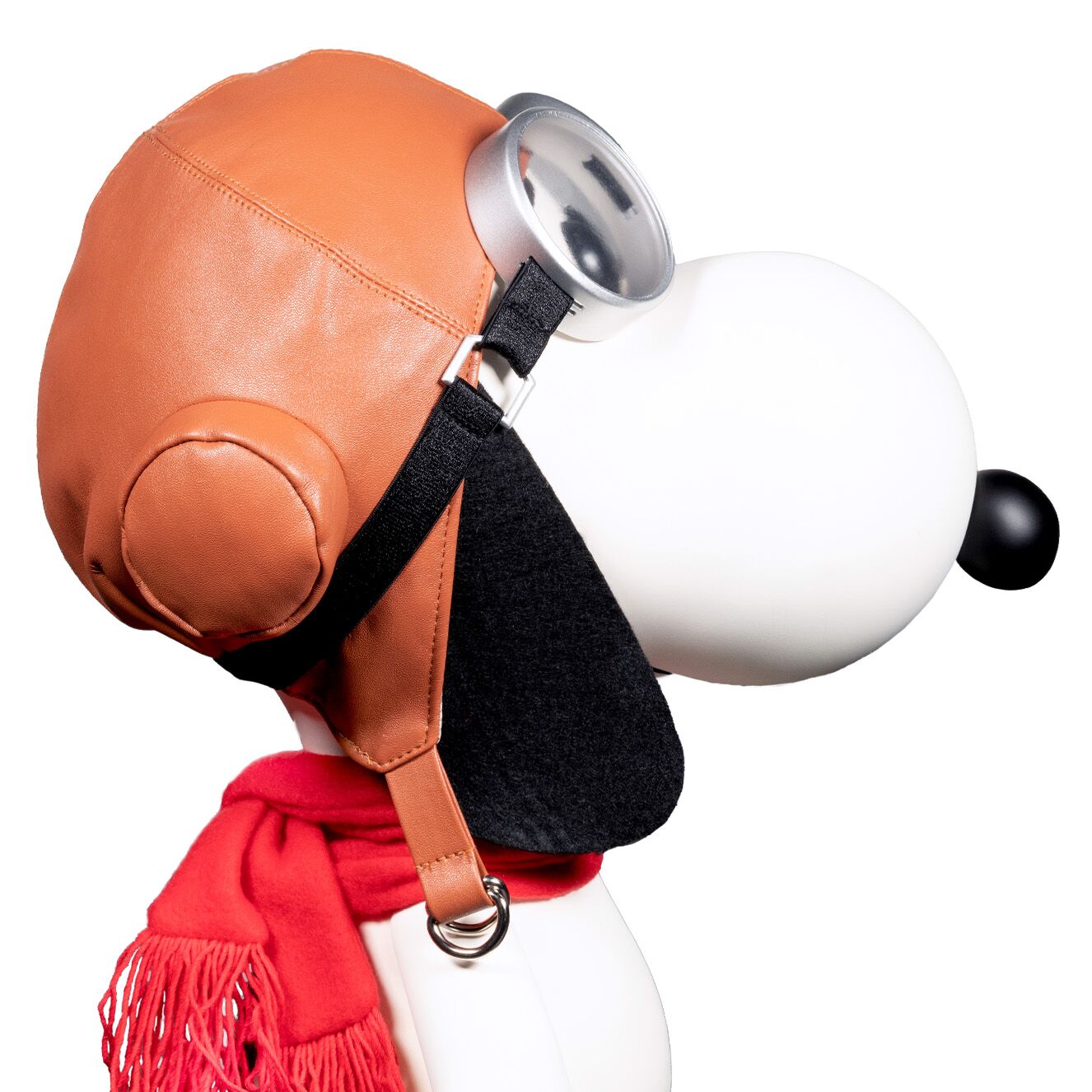 Side view of Snoopy Flying Ace vinyl figure with orange helmet, silver goggles and a red scarf.