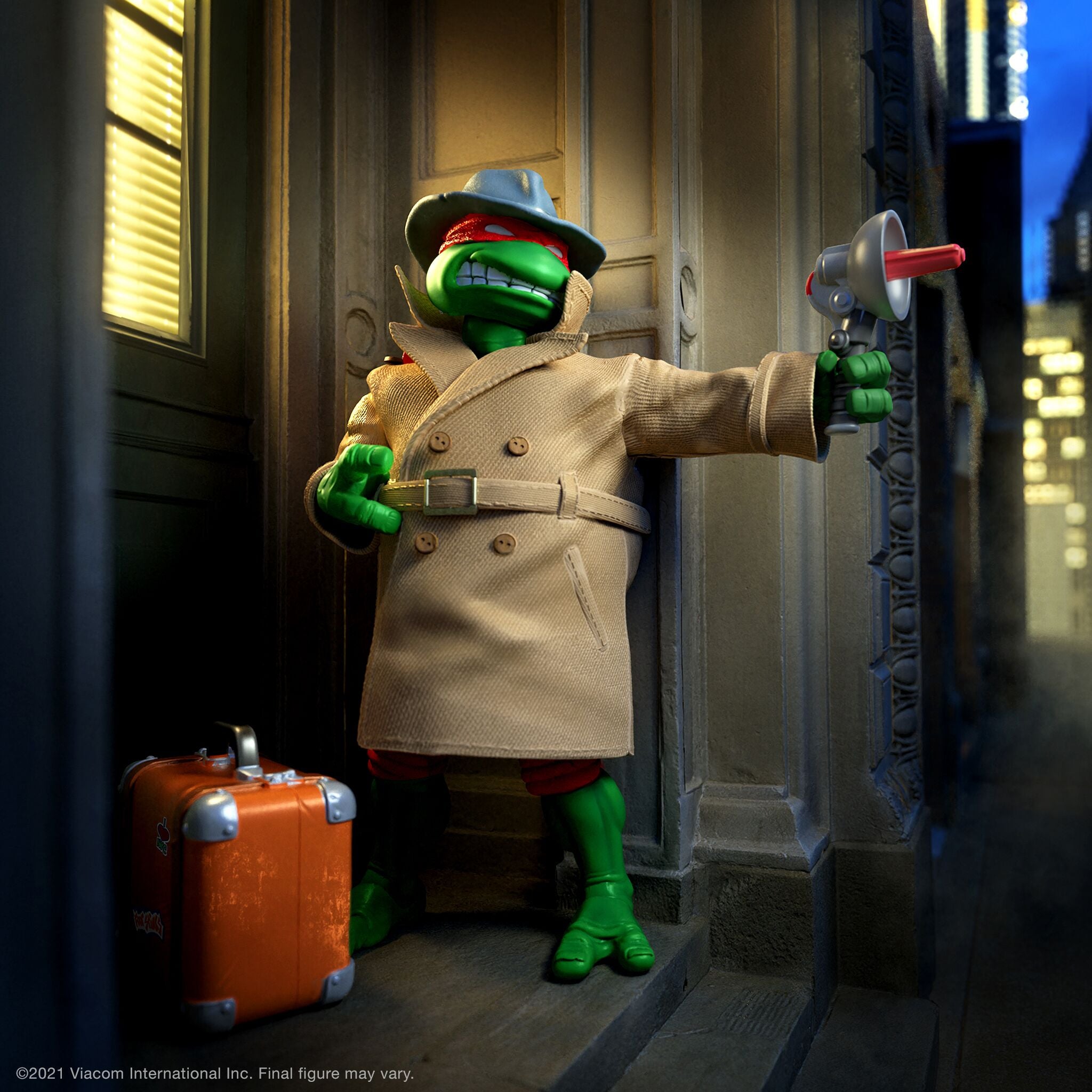 Raphael as a trench coat-wearing detective, holding a device, with an orange suitcase beside him