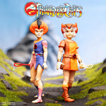 Two Thundercats Ultimates figures, WilyKit and WilyKat, standing on a grassy terrain