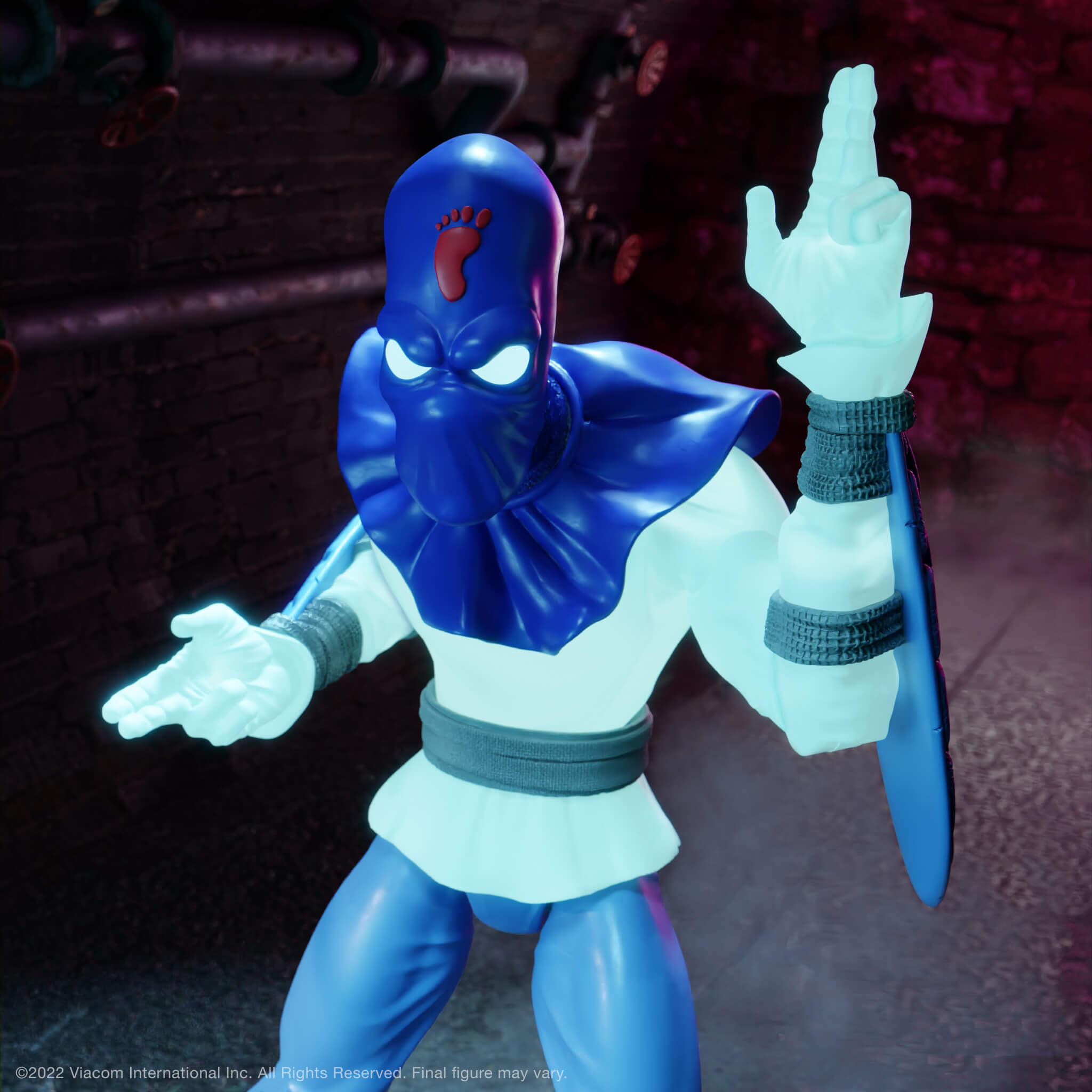 Foot Soldier from Teenage Mutant Ninja Turtles Ultimates glowing figure with blue armor, glowing eyes, and a raised glowing hand.