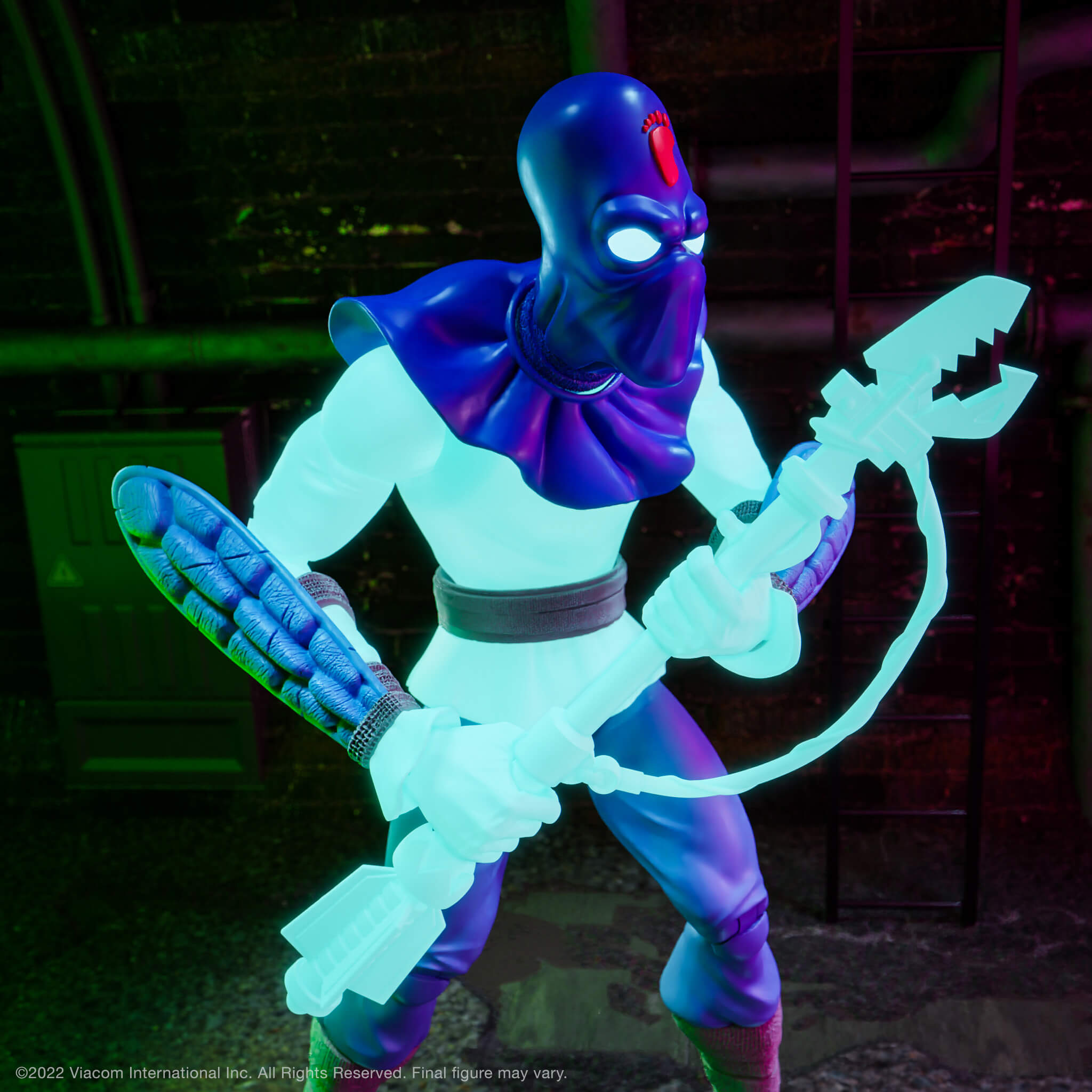 TMNT Ultimates Foot Soldier glow figure with oversized cyan blade in an action stance before a dark brick backdrop.
