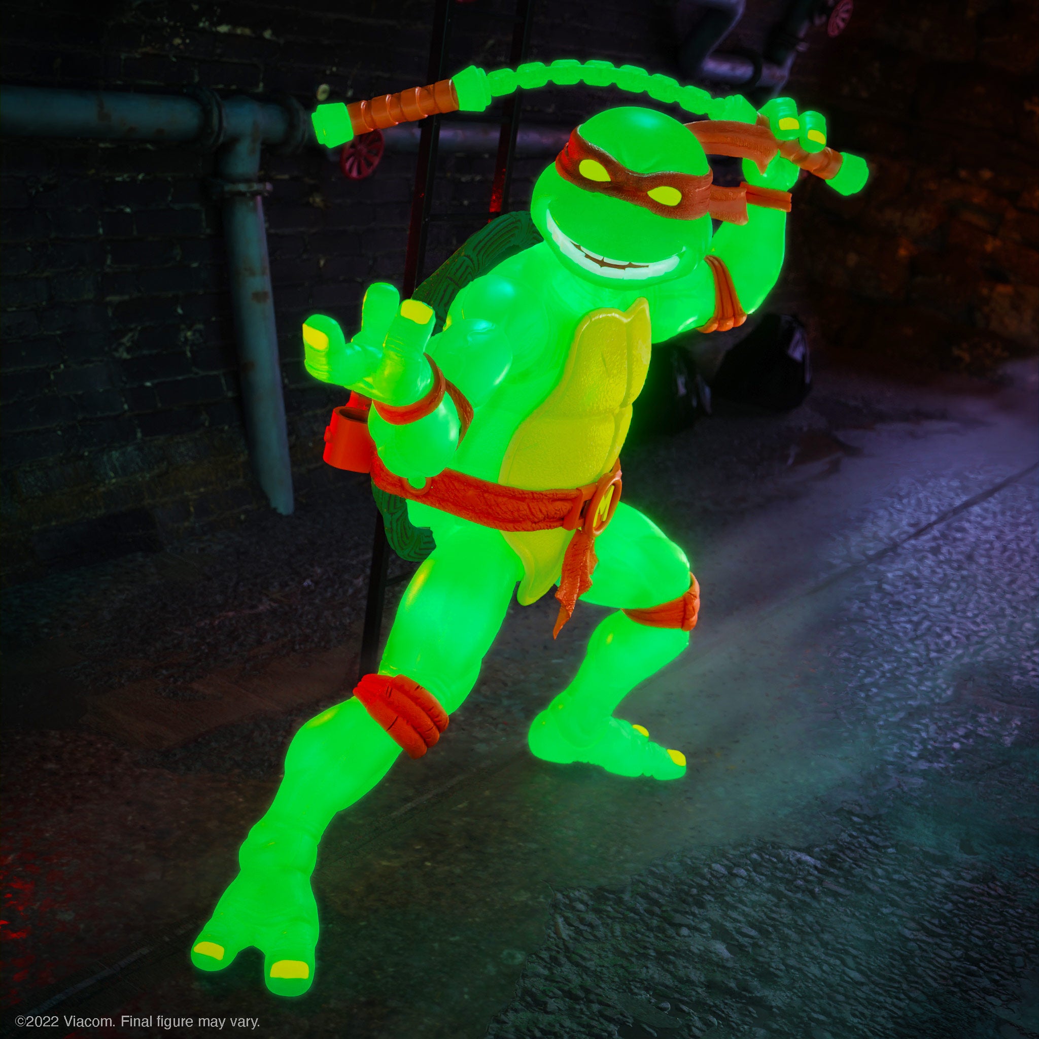 Michelangelo in neon Mutagen Ooze Glow leaps with glowing nunchaku against a dark background.