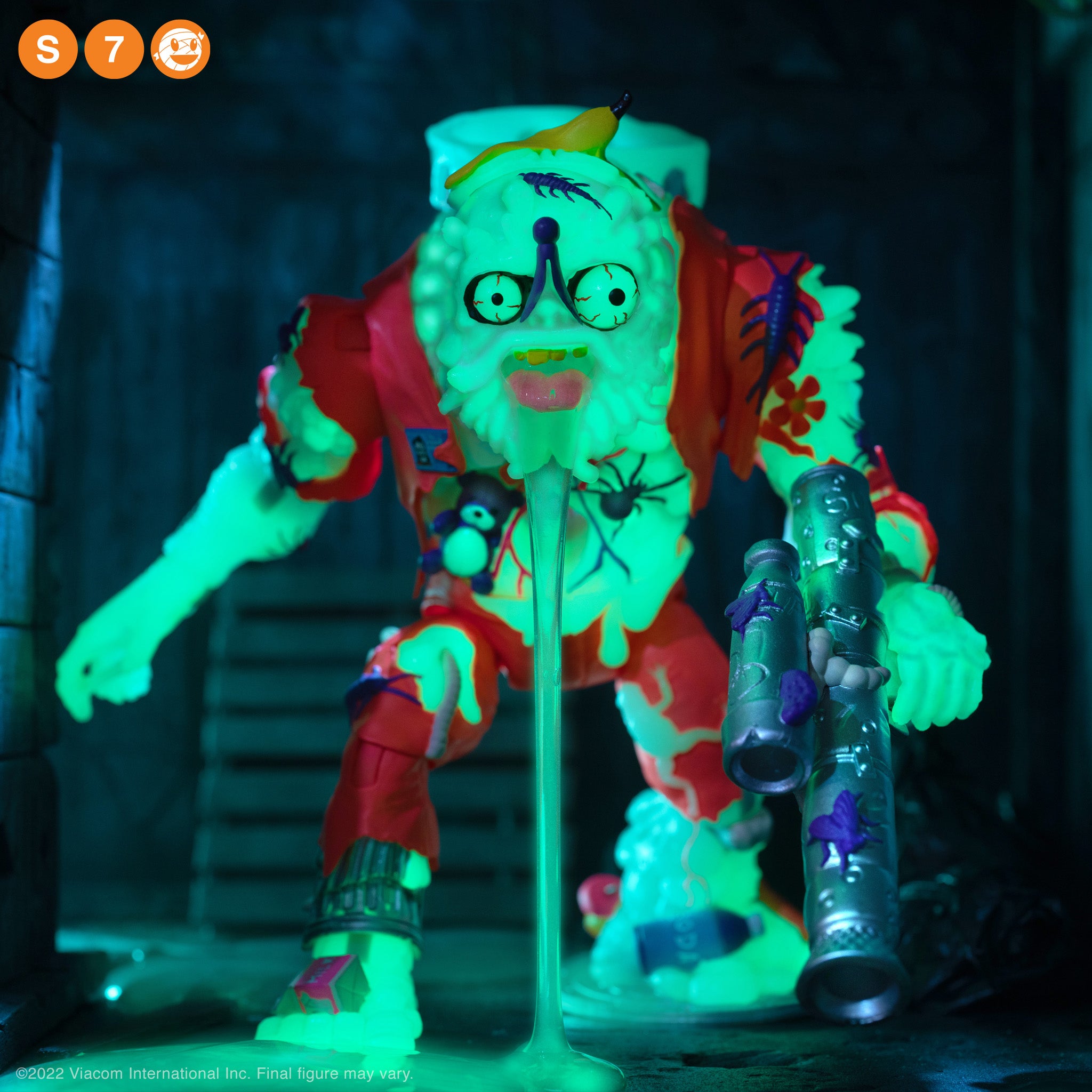 Glow in the dark Muckman and Joe Eyeball figure close up under blue lighting with neon green details