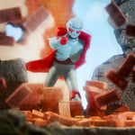 Blue Czarface ReAction figure with red cape among brick rubble.