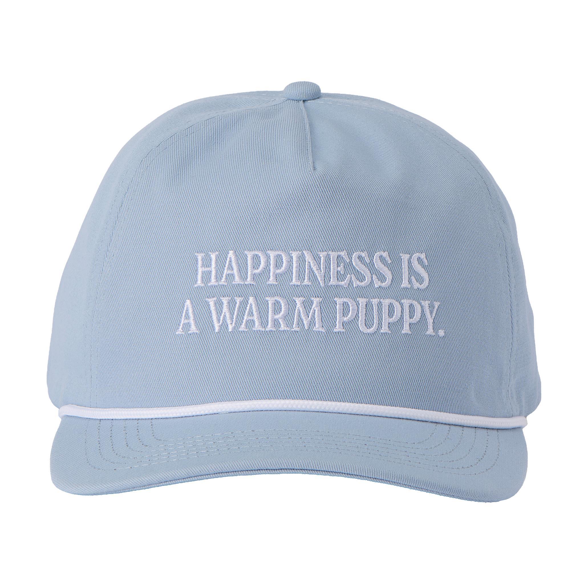 Close up of light blue Peanuts Happiness Hat with white embroidered text Happiness Is A Warm Puppy on the front