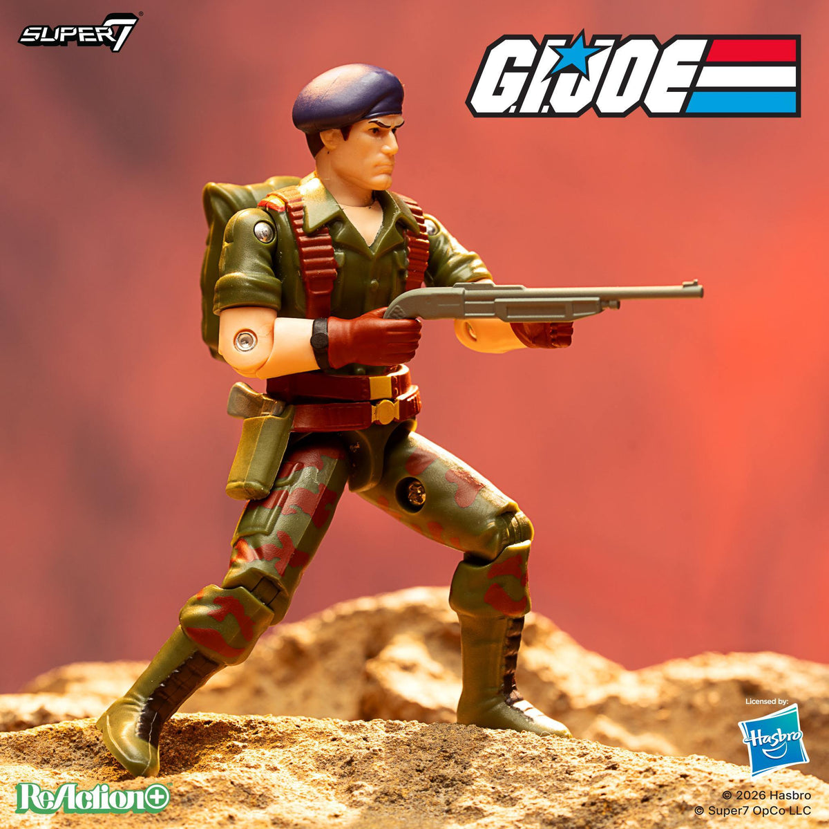 Flint action figure from G I Joe ReAction+ Wave 10 in green uniform with red ammo belt and rifle on a rocky base