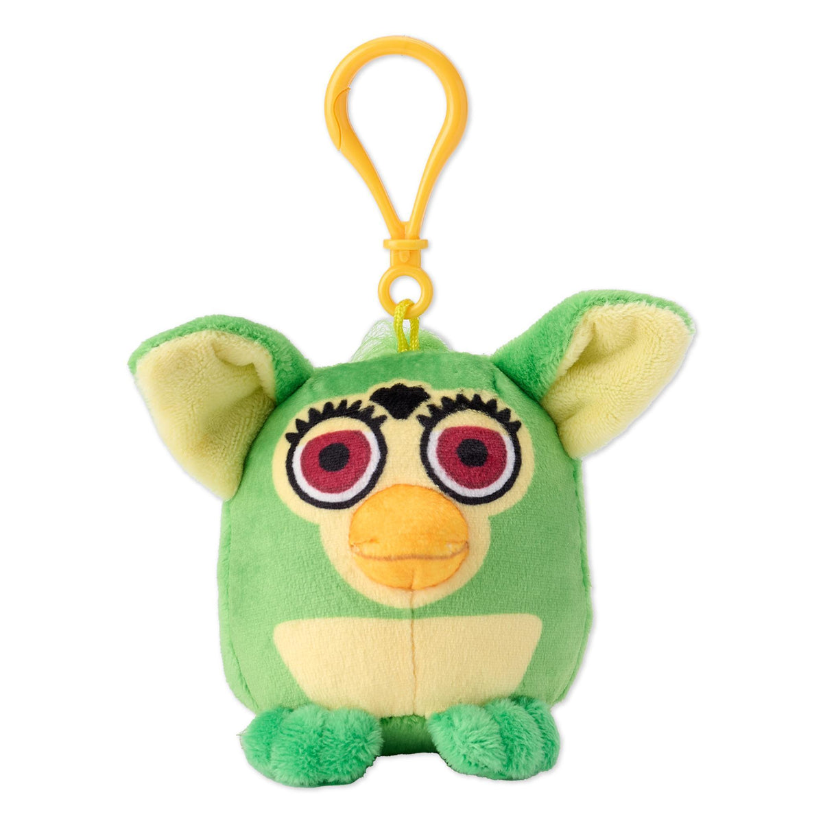 Close-up of a green Furby plush showing large red eyes orange beak and an orange top loop.