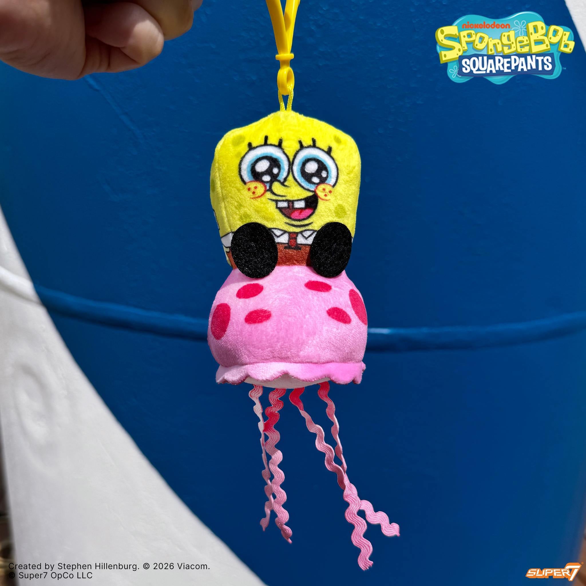 SpongeBob SquarePants plush keychain featuring SpongeBob riding a pink jellyfish