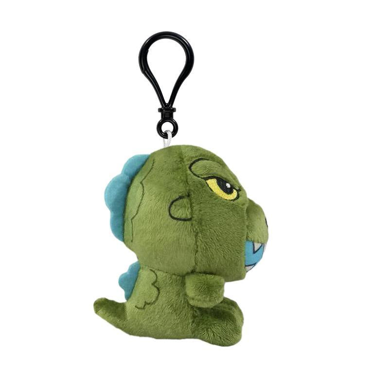 Back side view of a green dinosaur plush keychain with blue dorsal plates and a black clip.