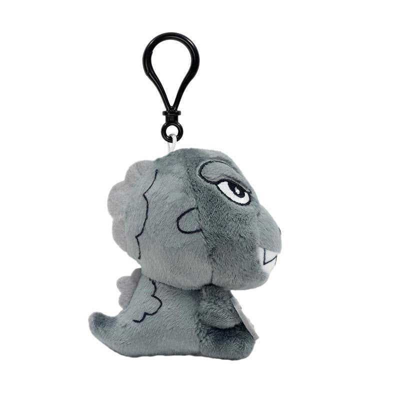 Back view of grey T rex plush keychain showing plates along the back and a small tail.