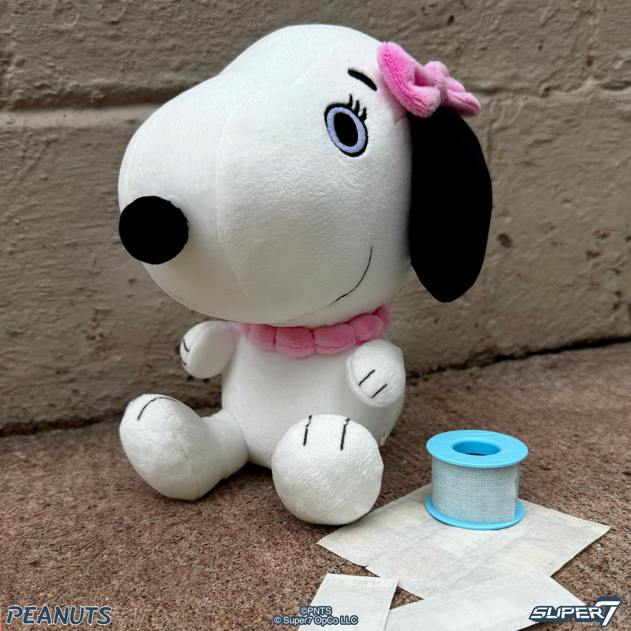 Belle the Peanuts plush Snoopy head with pink bow and black ears
