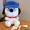 Olaf Peanuts plush wearing a bright blue hat, close-up of face on a wooden table.
