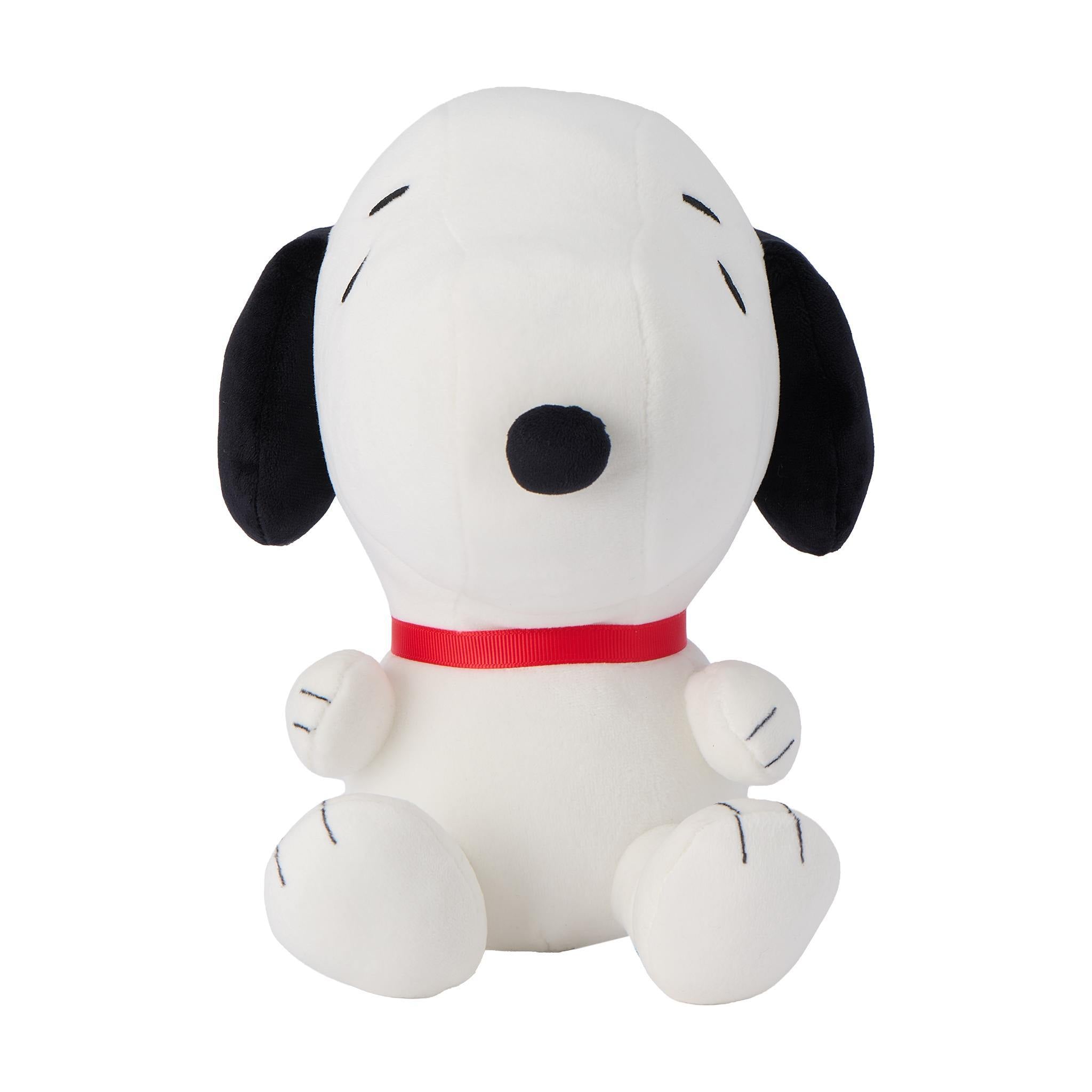 White Snoopy plush wearing a brown hat with a bright green band against a white background