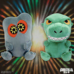 Two Godzilla plush toys, one gray with orange and yellow eyes, one green with yellow eyes and white teeth