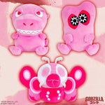 Three pink Godzilla plush toys: Godzilla, Hedorah, and Mothra