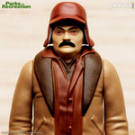 Close-up of a Ron Swanson figure torso in brown vest inside packaging