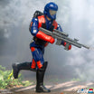 Close up of a GI Joe action figure in blue helmet and red vest wielding a large gray rifle against a smoky backdrop