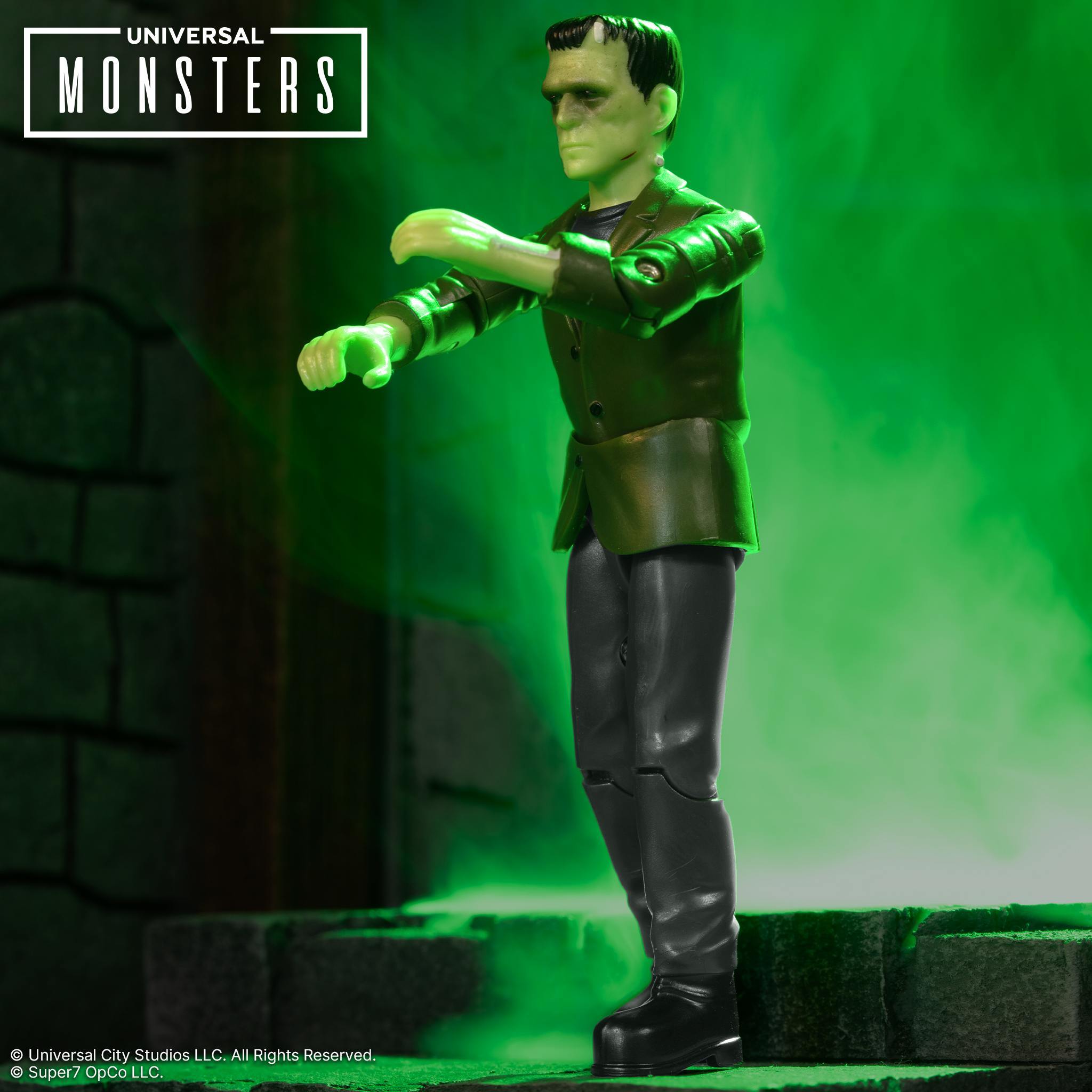 Frankenstein monster action figure in green jacket and black pants against green smoke background