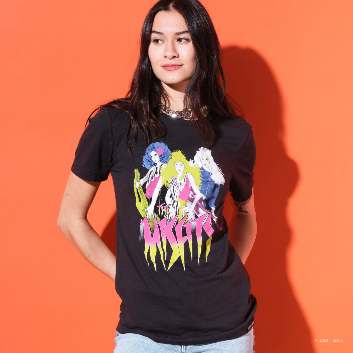 Woman wearing a black t-shirt with a graphic of three women and the text The Misfits