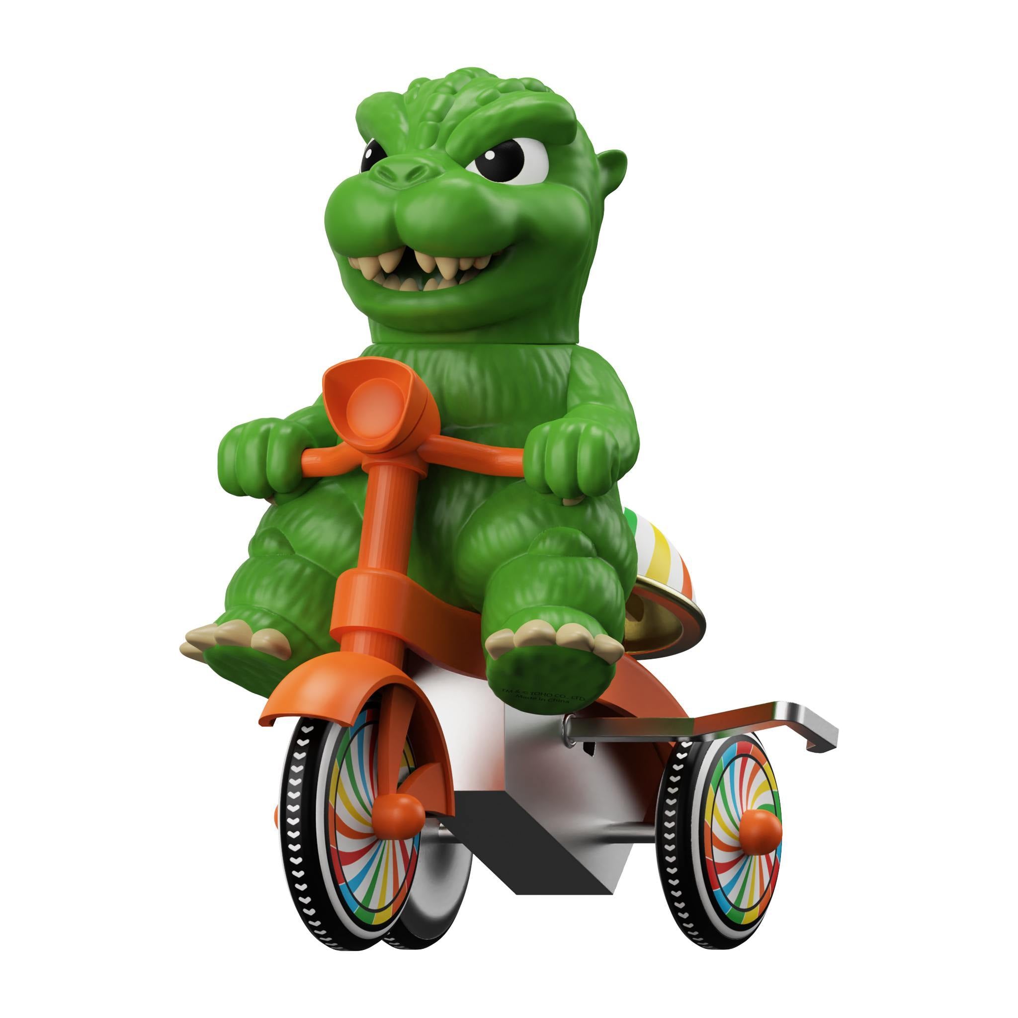 Close up of a green Godzilla head with a red tricycle handlebar